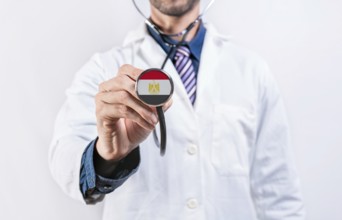 Iraq healthcare system, doctor holding stethoscope. Iraq health and medical insurance concept