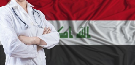Doctor with crossed arms on Iraq flag. Iraq health and care concept. Female doctor on Iraq flag