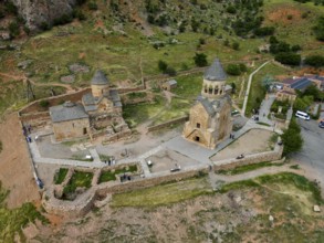 Close-up of an old stone church in a hilly landscape, aerial view, Noravank Monastery, Surb
