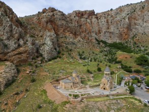 Historic churches embedded in a rocky mountain landscape, surrounded by green vegetation and
