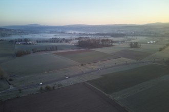 Agricultural fields and meadows in the early morning fog, Reuss Valley, Merenschwand, Freiamt,