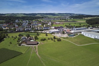 View of the village with the catholic parish church Mariä Geburt, on the right the industrial area,