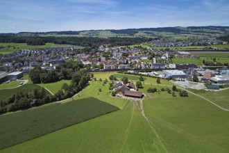 View of the village with the catholic parish church Mariä Geburt, on the right the industrial area,