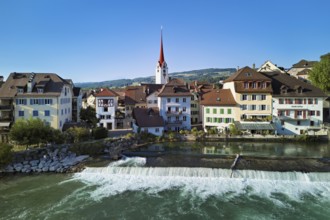 Old town with the Catholic Church of St Nicholas, in the foreground the weir on the river Reuss,