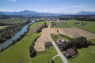 Main road leads through the hamlet of Reussegg, on the left the river Reuss, behind the Pilatus and