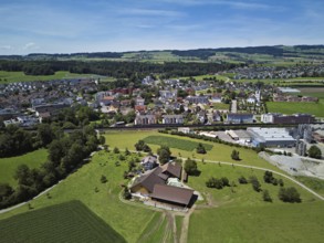 View of the village with the Catholic parish church Mariä Geburt, on the right the industrial area,