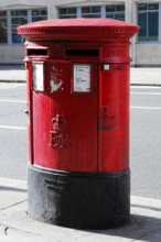 Red letterbox on an empty London street, London, London region, England, United Kingdom