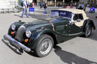 Green vintage convertible parked on a street, London, London region, England, United Kingdom