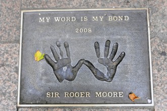 Plaque with handprints and the inscription by Sir Roger Moore, My Word Is My Bond 2008, London,