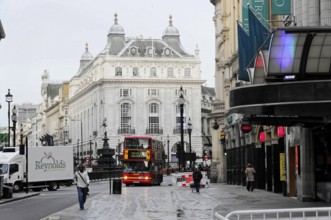 London, England, Great Britain, Europe, Red double-decker bus in a city street in front of historic