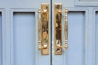 London, England, Great Britain, Europe, Close-up of golden door handles on a blue door
