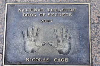 Nicolas Cage's handprints for National Treasure on a metal plate on the pavement, London, England,