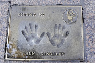 Ben Kingsley's handprints for Cinema 100 on a metal plate in the pavement, London, England, Great