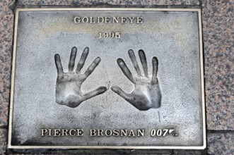 Handprints of Pierce Brosnan for the film GoldenEye on a metal plate on the pavement, London,