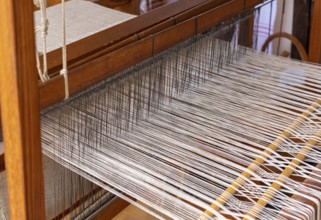 Closeup shot of a historic wooden loom with threads