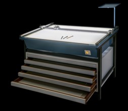 Illuminated layout table with open drawers isolated in black back