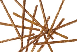 Closeup of some crossed salt sticks in white back