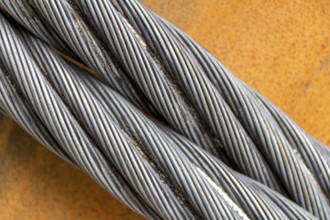 Closeup shot of wire ropes on rusty ground
