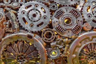 Full frame warm illuminated metallic mechanical background with gear wheels and other material