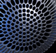 Abstract detail of a blue illuminated metallic cover in black back