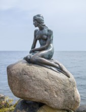 Bronze statue located in Copenhagen in Denmark named The Little Mermaid
