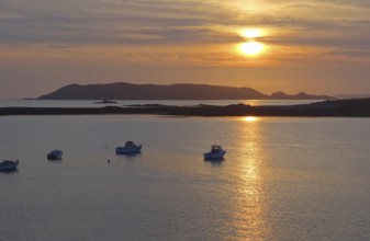 Idyllic sundown with some boats at the Pink Granite Coast in Brittany, France