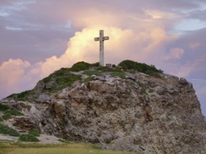 Colorful sundown scenery on a caribbean island named Guadeloupe including a summit cross on