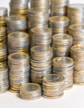 Lots of stacked 1 euro coins