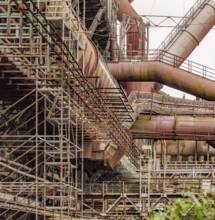 Weathered rusty industrial scenery with old corroded steel girders and metal tubes