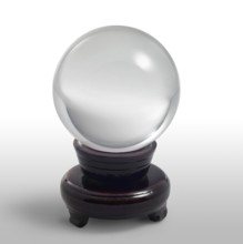 A clear crystal ball and stand in light grey gradient back