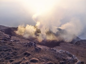 Smoky crater scenery at Stromboli volcano near Sicily at evening time