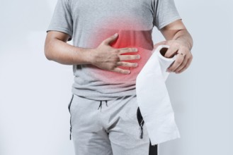 Person with digestive problems holding toilet paper isolated. Digestive disease concept