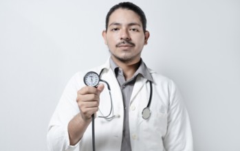 Doctor showing blood pressure monitor isolated. Male doctor holding tensometer