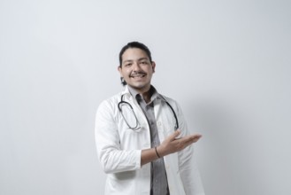 Smiling doctor showing to the right. Doctor pointing to his right