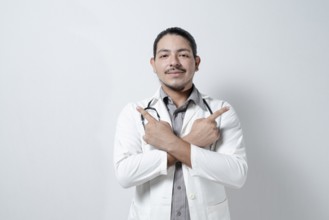 Young doctor pointing up to both sides on isolated