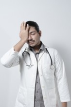 Exhausted young doctor on isolated