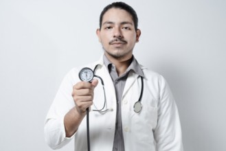 Doctor showing blood pressure monitor isolated. Male doctor holding tensometer