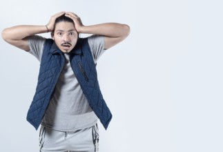 Shocked man clutching his head in excitement