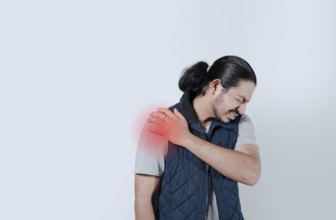 Man with shoulder pain highlighted in red. Shoulder pain concept on isolated background