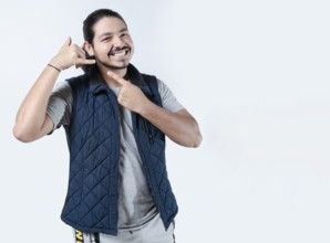 Smiling man gesturing call me on isolated background. Young man makes a calling gesture on a white