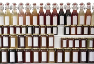 Lots of preserving glasses and bottles filled with colorful content