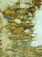 Weathered stone wall with yellow and grey stones, showing a rough, rustic texture Styria Austria