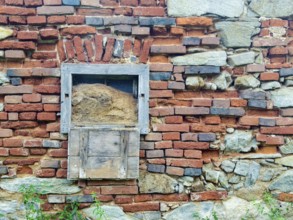 Weathered brick wall with wooden box and natural stones, gives a rustic impression Styria Austria