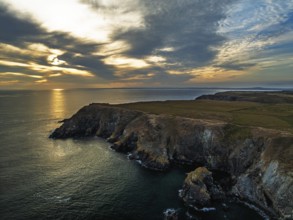 Sunset over Kynance Cove from a drone, Mount's Bay, Lizard Point, Cornwall, England, United Kingdom