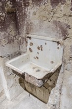 Old dilapidated washbasin in the Ohrbeck labour education camp, Hasbergen, Lower Saxony, Germany