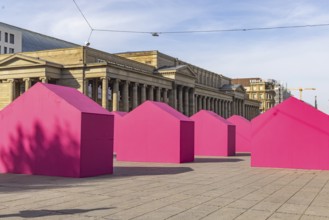 Twelve houses in bright magenta stand on Stuttgart's Schlossplatz in front of the art museum. The