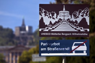 Bergpark Wilhelmshöhe, sharp sign with park prohibition notice and blurred Hercules building,
