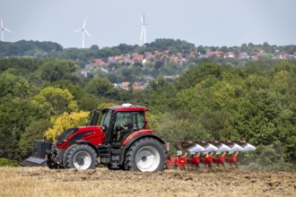 Tractor ploughs up a harvested grain field, south of Billerbeck in Münsterland, North