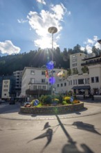 Roundabout in City and with Blue Sky and Clouds with Sunbeam in a Sunny Summer Day in St Moritz,