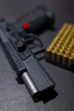 Modern Elegant Sport Handgun with Gas Pedal and Skirt and Bullet on Grey Background in Switzerland
